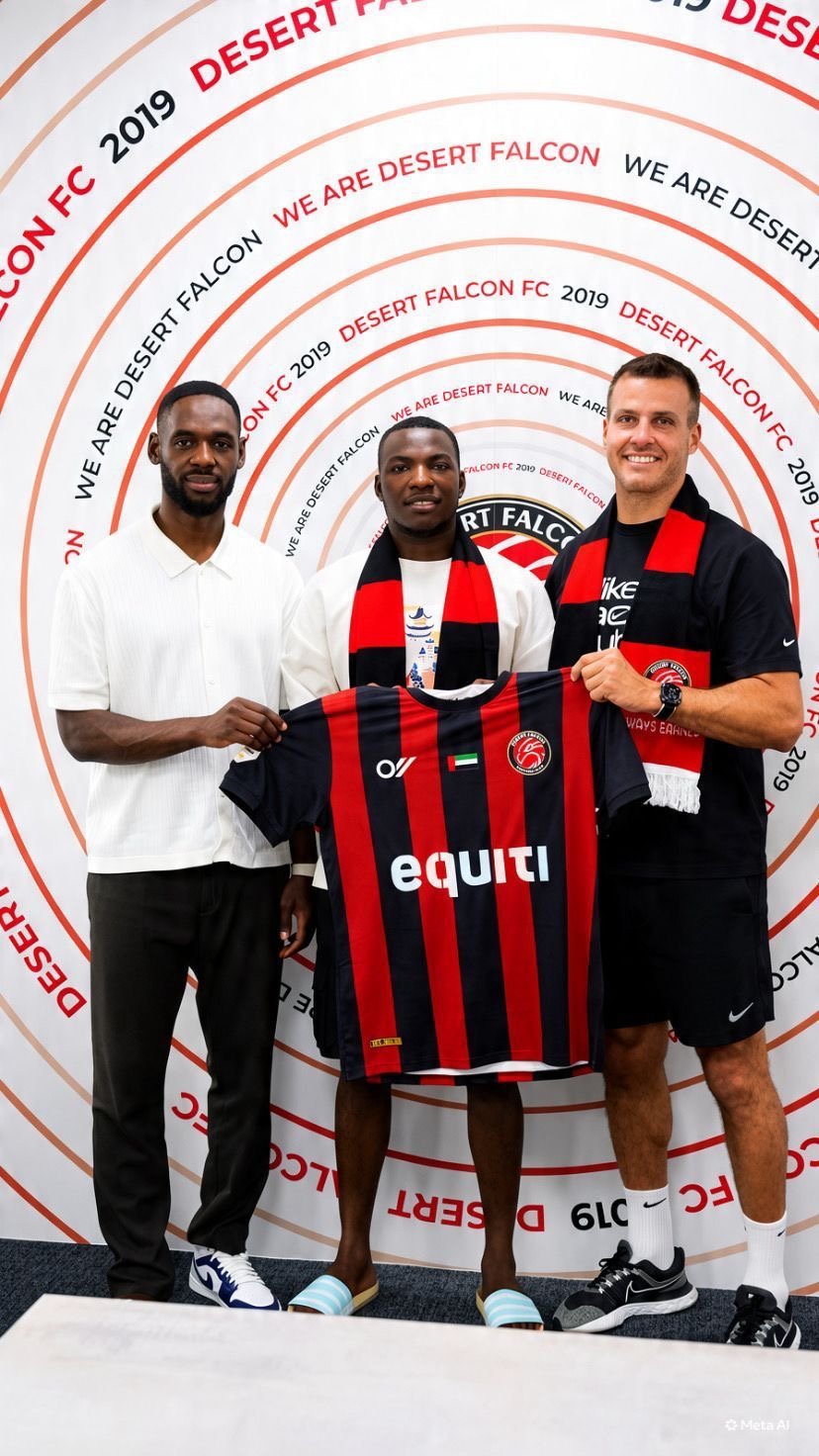 Three men pose together holding a red and black striped Desert Falcon FC jersey at a 2019 team event